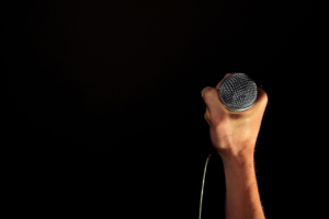 male hand with microphone isolated on black 1630672 1278x853